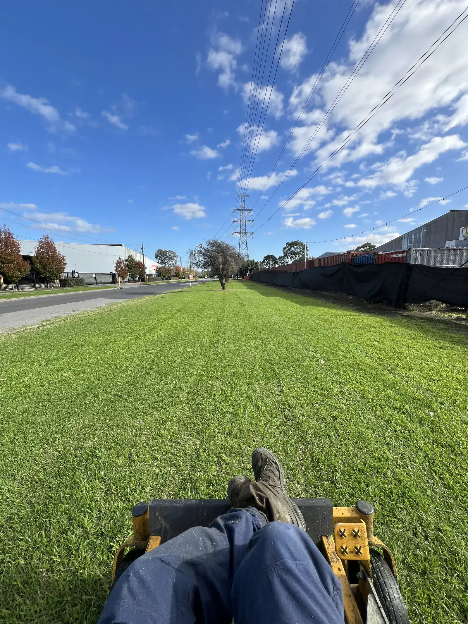 Acreage mowing from the seat of the ride-on across a large open block